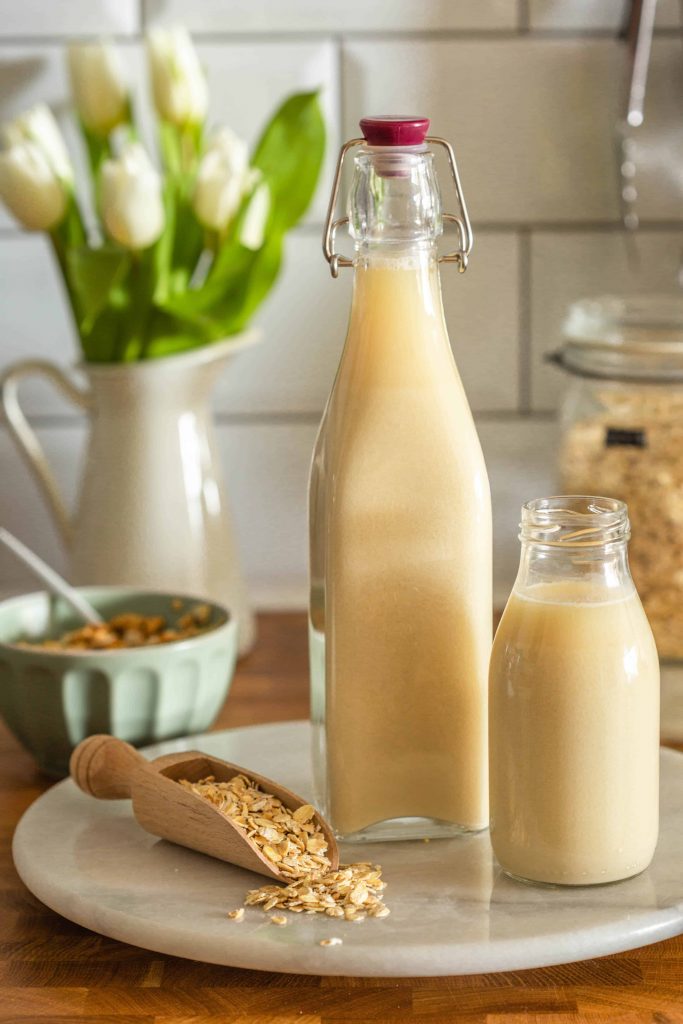 homemade oat milk in bottles and jumbo oats