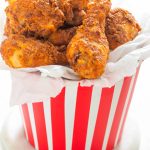 cooked kfc chicken in a takeaway paper bucket