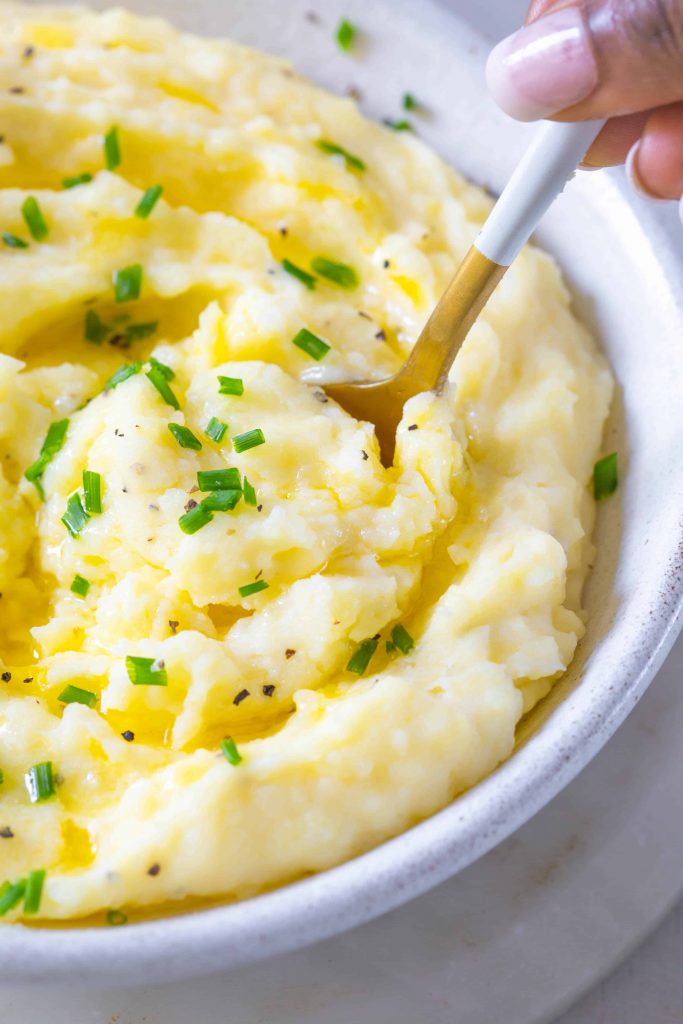 mashed potatoes butter and chives in a bowl
